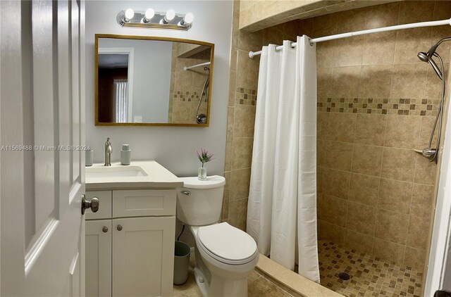 bathroom with a shower with curtain, vanity, and toilet