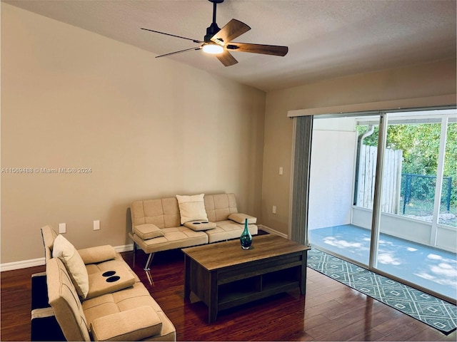 living room with dark hardwood / wood-style flooring and ceiling fan