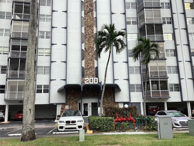 200 Diplomat Pkwy Unit 531, Hallandale Beach, FL 33009 - view of building exterior featuring uncovered parking