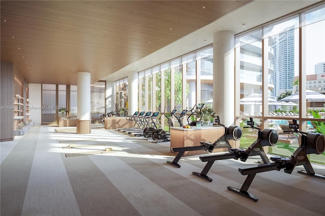 gym featuring light carpet and wooden ceiling