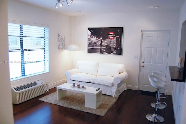 living room featuring a wealth of natural light and dark hardwood / wood-style floors