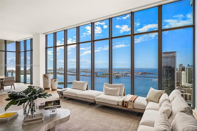 sunroom / solarium featuring a water view