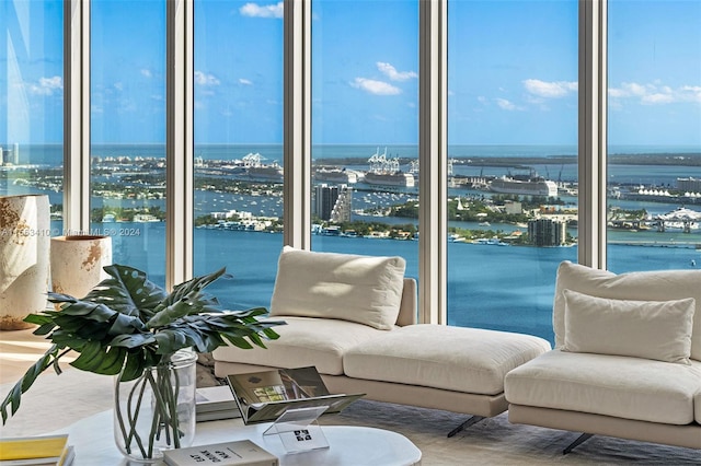 sunroom / solarium featuring a water view