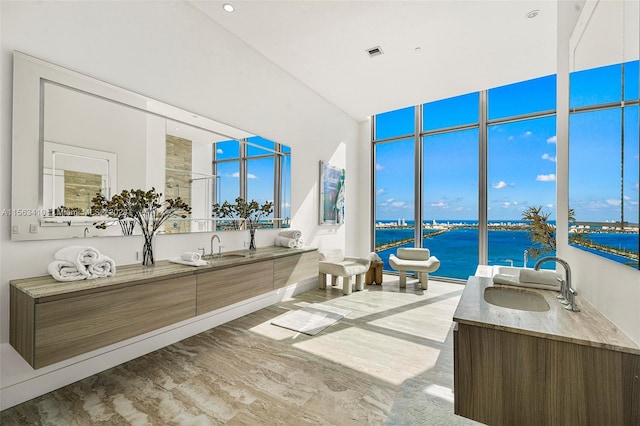 bathroom featuring a water view, hardwood / wood-style floors, and dual vanity