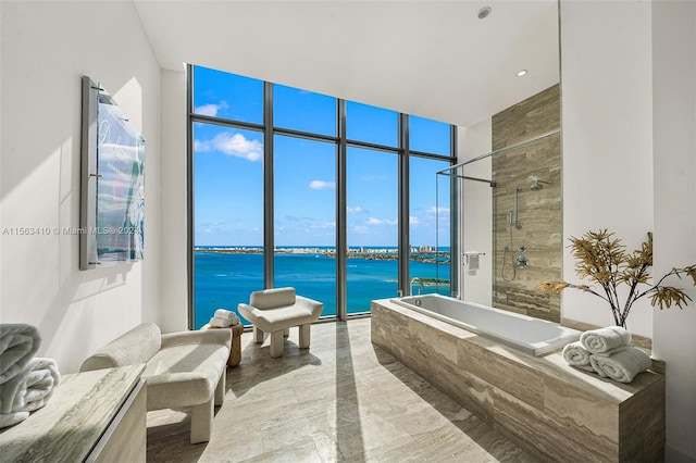 bathroom featuring a water view, a wall of windows, independent shower and bath, and tile flooring