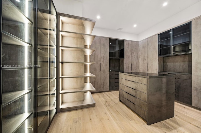 spacious closet featuring light hardwood / wood-style floors