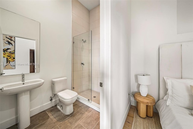 bathroom with an enclosed shower and toilet