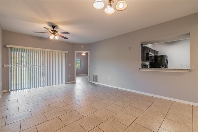 unfurnished room featuring ceiling fan and light tile flooring