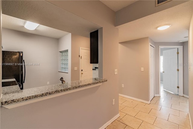 hallway featuring light tile flooring