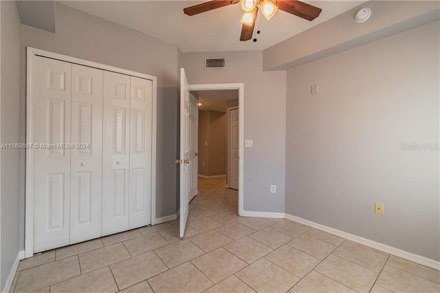 unfurnished bedroom with a closet, ceiling fan, and light tile flooring