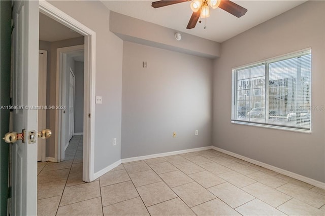 spare room featuring ceiling fan and light tile flooring