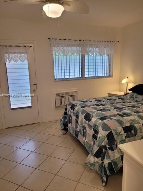 tiled bedroom with ceiling fan