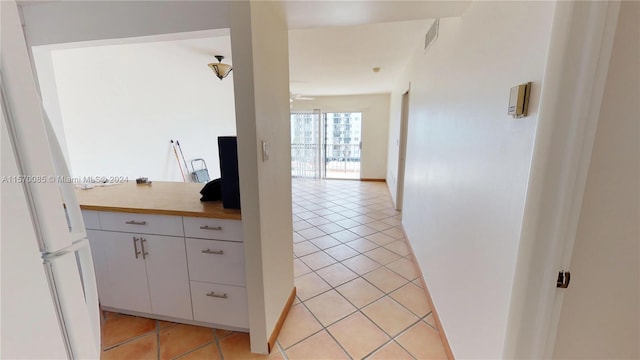 hallway featuring light tile flooring