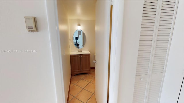 hallway featuring sink and light tile flooring