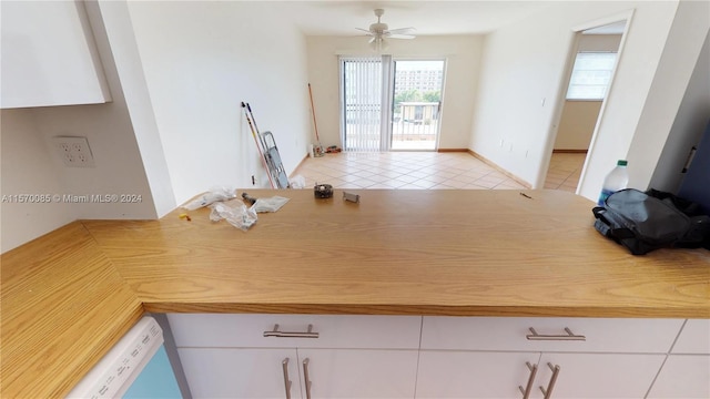 kitchen featuring white cabinets, ceiling fan, and light tile floors