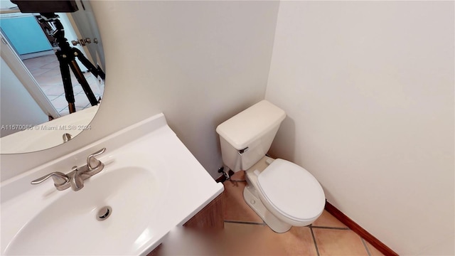 bathroom with sink, toilet, and tile floors