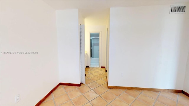 spare room with light tile floors