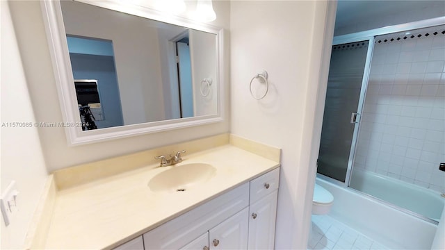 full bathroom with oversized vanity, toilet, tile floors, and combined bath / shower with glass door