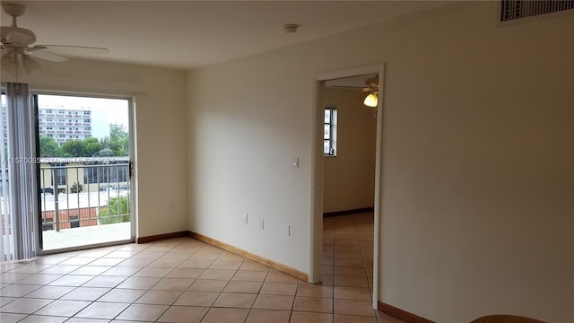 tiled empty room featuring ceiling fan