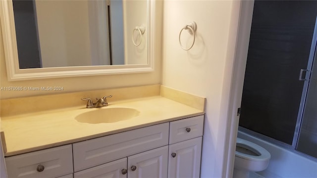 full bathroom with vanity, toilet, and enclosed tub / shower combo