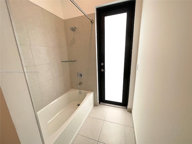 bathroom featuring tiled shower / bath and tile floors