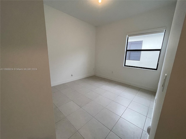 unfurnished room featuring light tile flooring