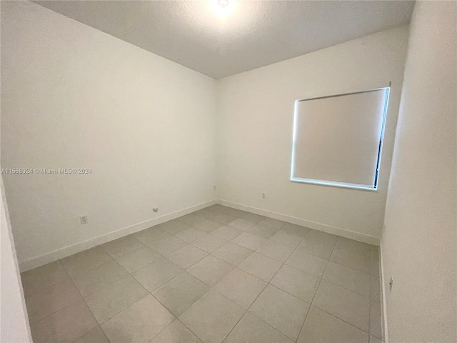 spare room with light tile floors