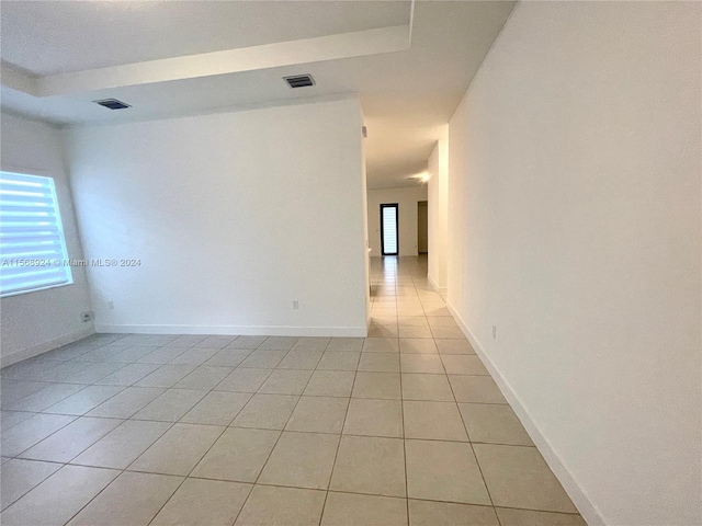 unfurnished room featuring light tile flooring