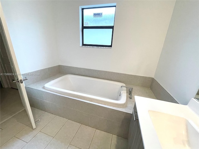 bathroom featuring vanity, tile floors, and tiled bath