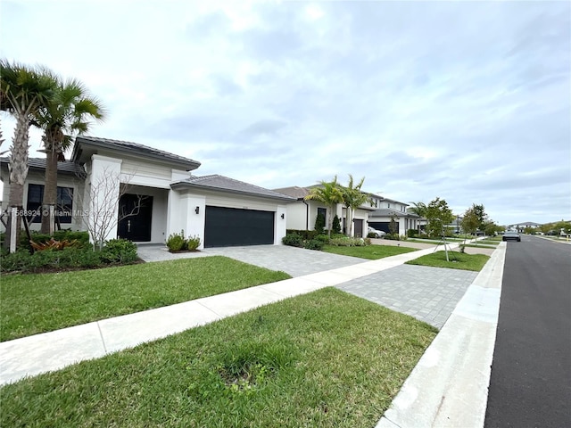 view of front of property with a front yard and a garage