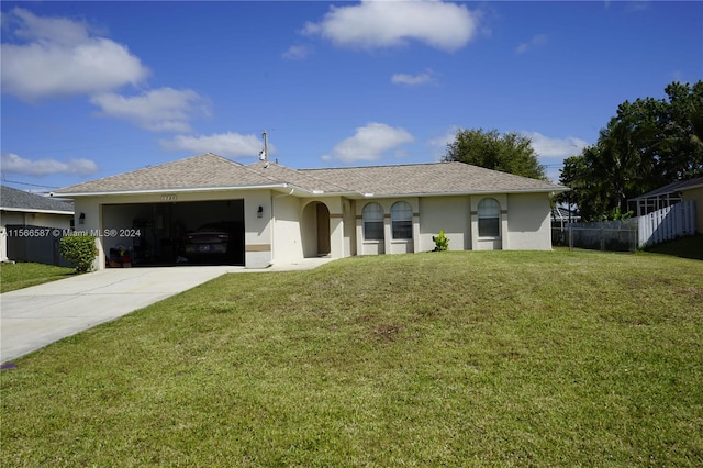 single story home with a garage and a front lawn