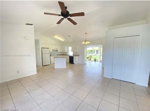 unfurnished living room featuring vaulted ceiling, ceiling fan with notable chandelier, and light tile floors