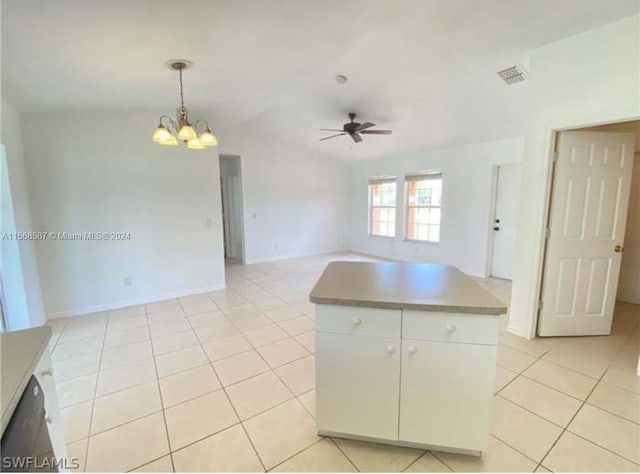 kitchen featuring decorative light fixtures, ceiling fan with notable chandelier, white cabinetry, light tile floors, and lofted ceiling