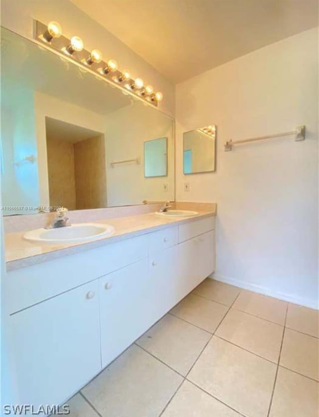 bathroom with tile floors and dual vanity