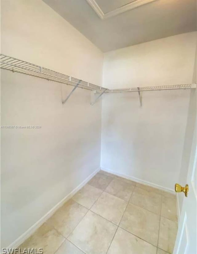 spacious closet with light tile flooring