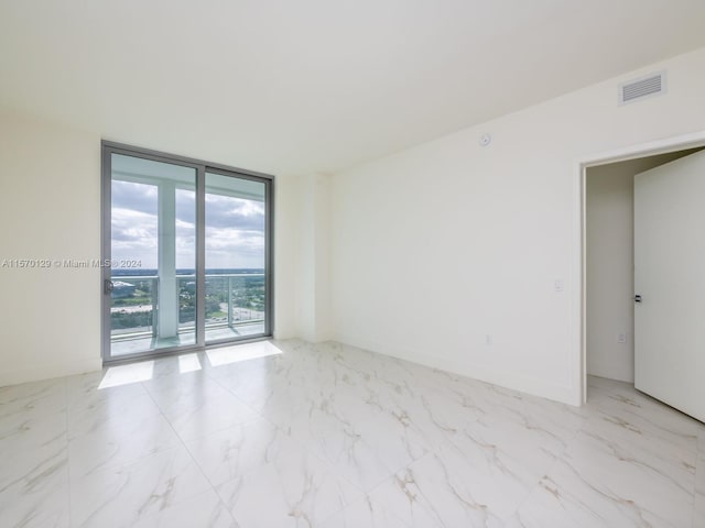 tiled spare room with expansive windows