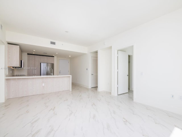 unfurnished living room with light tile flooring