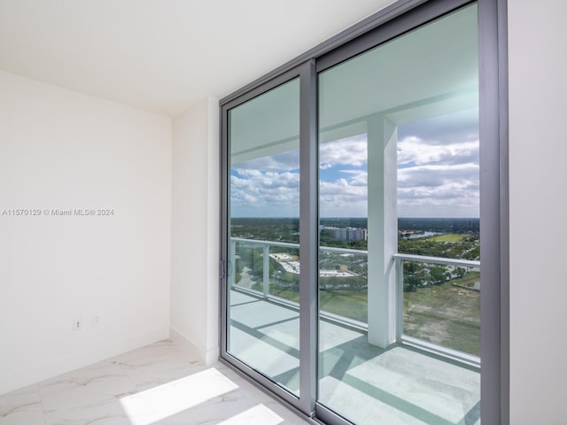 entryway with a wealth of natural light and light tile floors