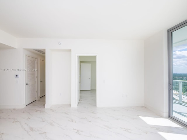 spare room featuring light tile flooring