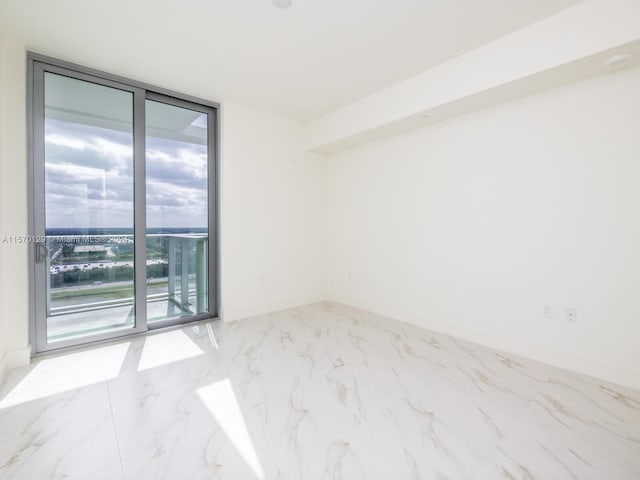 tiled spare room with floor to ceiling windows