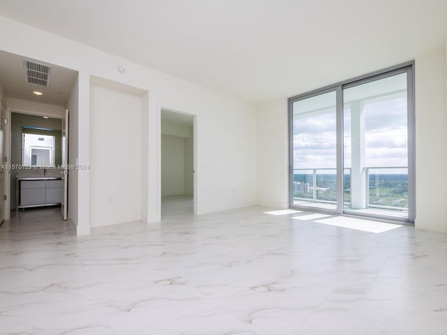 tiled empty room with a wall of windows