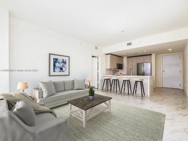 living room featuring sink and light tile floors