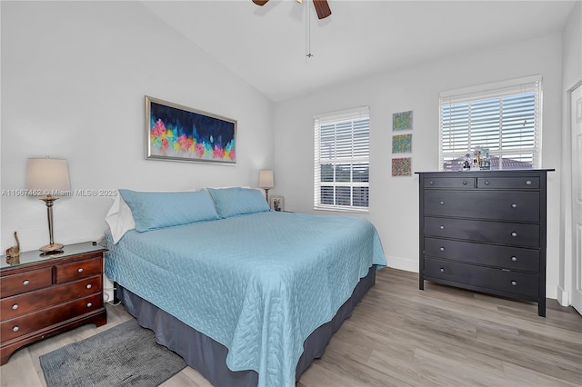 bedroom with light wood-type flooring, vaulted ceiling, and ceiling fan