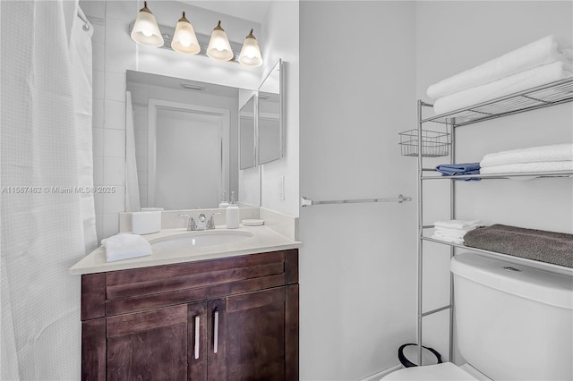 bathroom with vanity and toilet