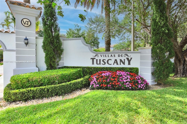 community sign featuring a lawn