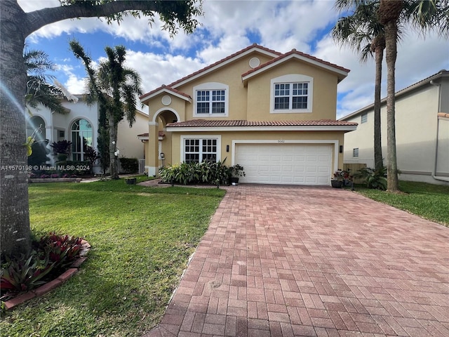 mediterranean / spanish house with a front yard and a garage