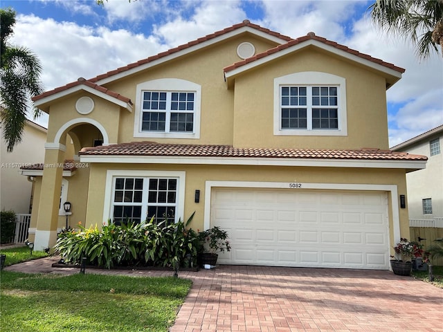 mediterranean / spanish-style house with a garage