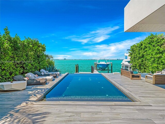 pool at night featuring an outdoor living space