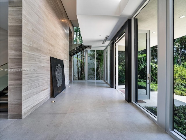 hallway featuring french doors and a wall of windows