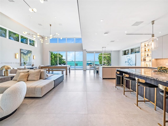 playroom featuring a high ceiling, billiards, and concrete flooring